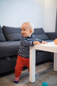 baby_holding_onto_table