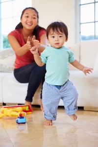 toddler_taking_first_steps_with_mom